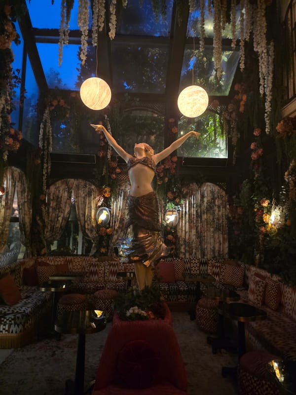 Inside an ornate, dimly lit Parisian lounge