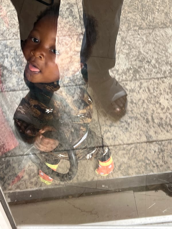 Toddler plays with ball and crackers in Nigerian home