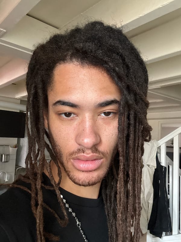 Man with dreadlocks photographed indoors in Paris apartment