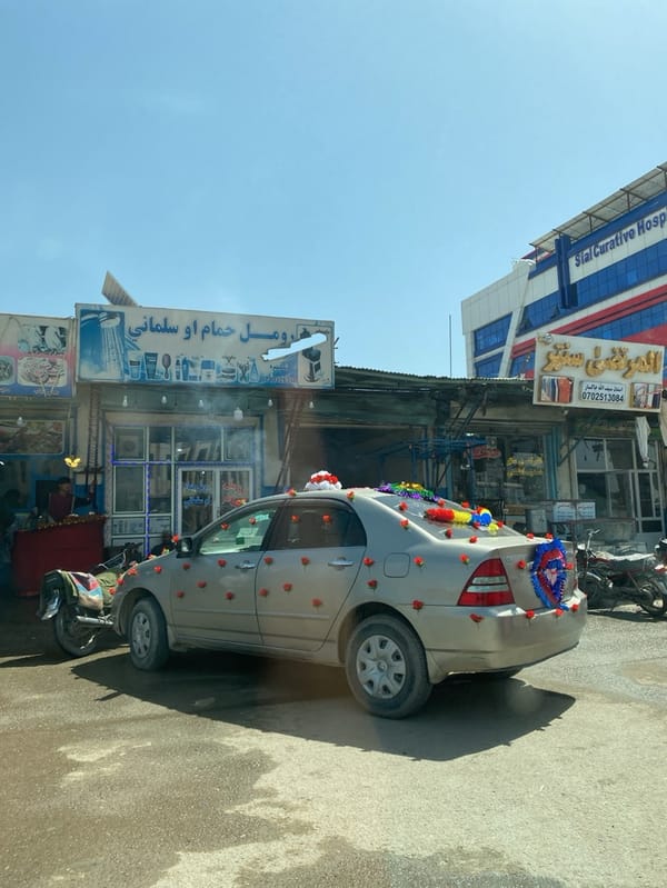 Decorated car and traditional-dressed pedestrian spotted in Kandahar street