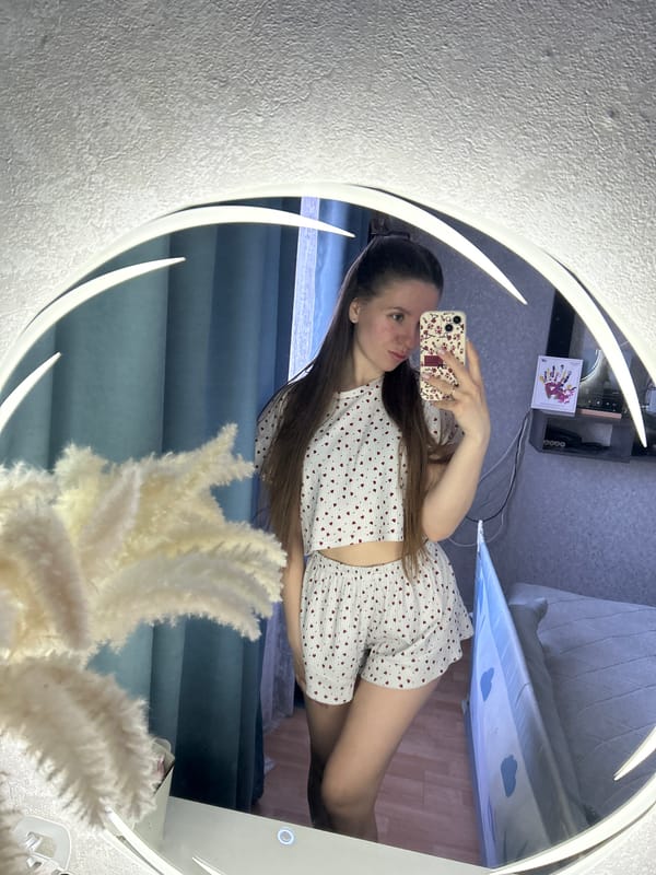 Woman takes selfie, rests in bedroom in Klin, Russia