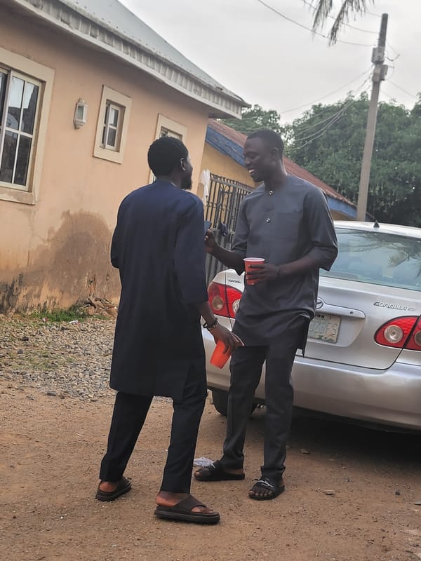 Men gather outside building in Jos, Nigeria