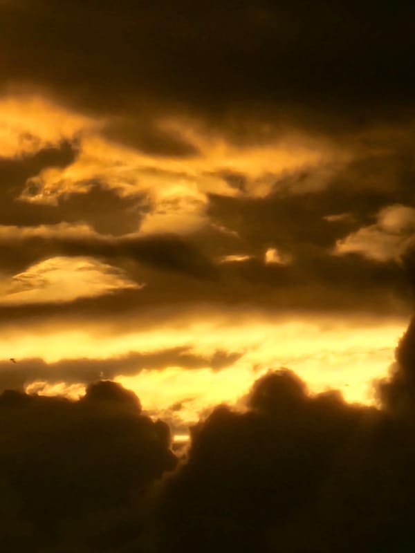 Storm clouds glow orange at the horizon over Khimki