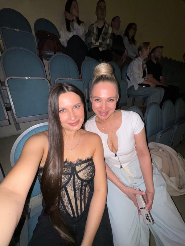 Two women take selfies at evening theater event in Odintsovo