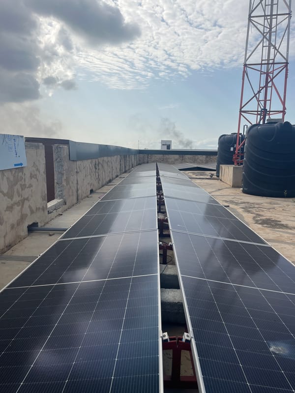 Solar panels and urban infrastructure viewed from Accra rooftop