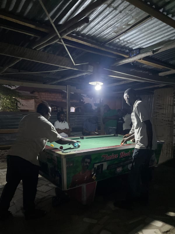 Pool tables, dim interiors, and street-level repairs in Dar es Salaam