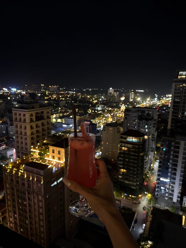 Rooftop cocktails and city lights in Phnom Penh at night