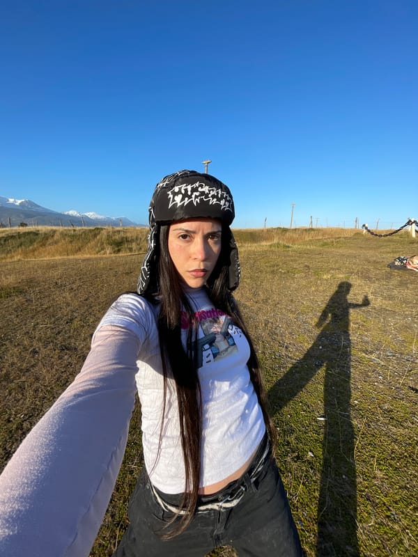 Woman rests on grassy field in Ushuaia, Argentina