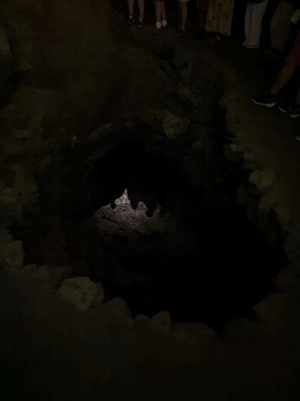 Tourist explores Cueva de los Verdes lava tube cave