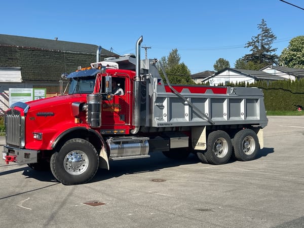 Red dump truck photographed multiple times in Surrey