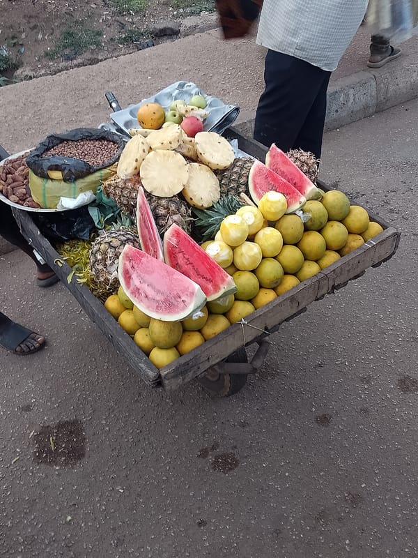 Street vendors sell fruits and nuts in Bukuru, Nigeria