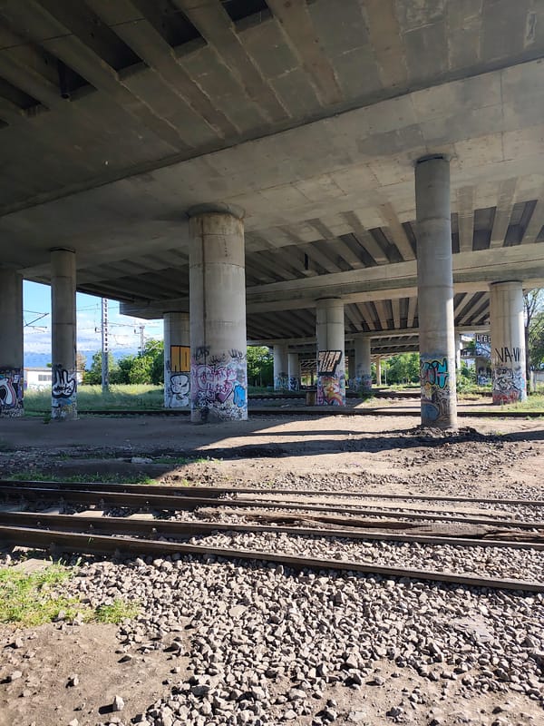 Railway infrastructure documented under graffitied overpass in Plovdiv