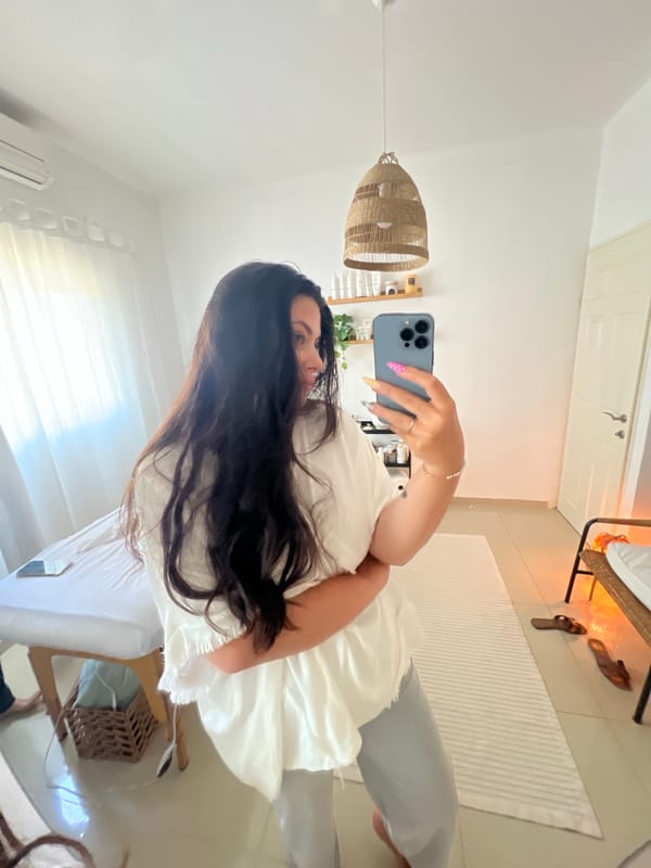 Person takes selfie with blue phone in Kiryat Bialik
