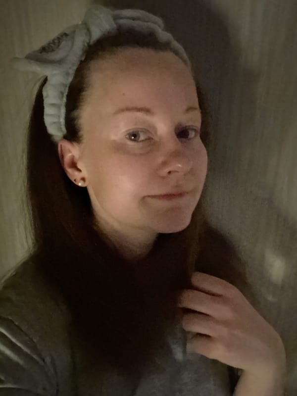 Woman photographed in Moscow wearing "ENOUGH" headband during afternoon