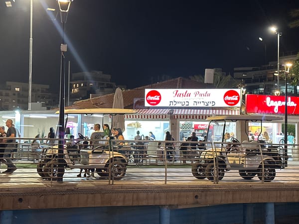 Nahariyya's beachfront promenade lit up on a summer night