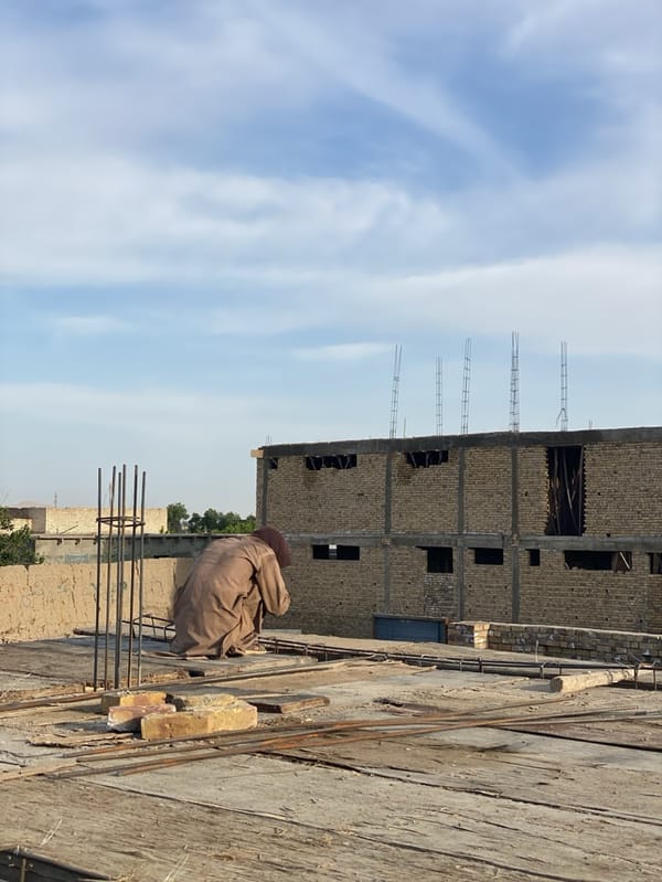 Men rest on construction rooftop in Kandahar