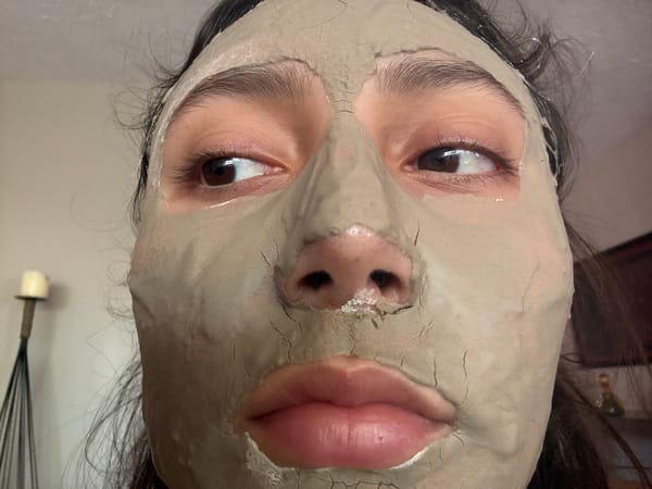 Person photographed wearing cracked clay facial mask in Mexico City