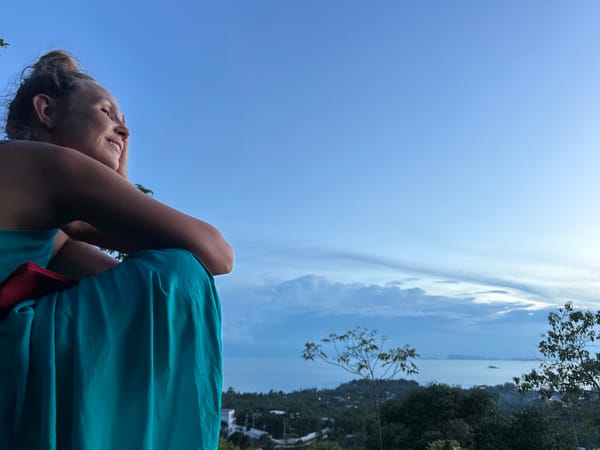 Sitting on the rocks above Koh Phangan's ocean panorama
