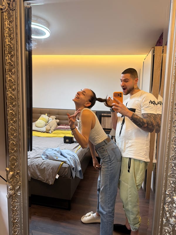 Couple takes mirror selfies in Sofia bedroom