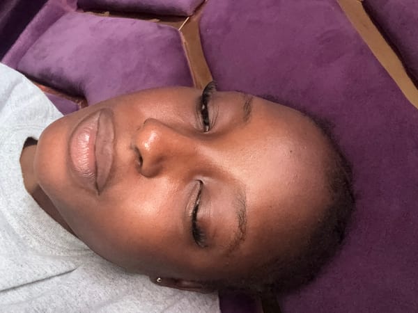 Woman photographed relaxing on purple furniture in Nigeria