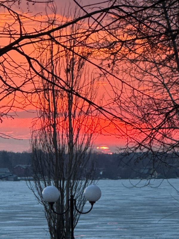 Dramatic sunset captured along Votkinsk waterfront with scooter rider