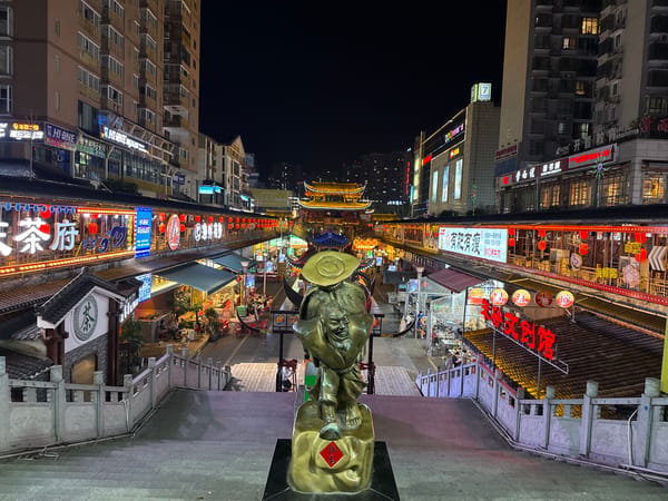 Night market bustles under neon lights in Zhangjiajie