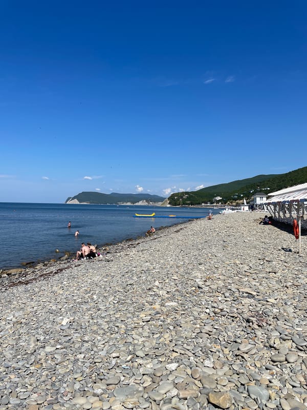 Calm summer morning at Shirokaya Balka's Black Sea pebble beach