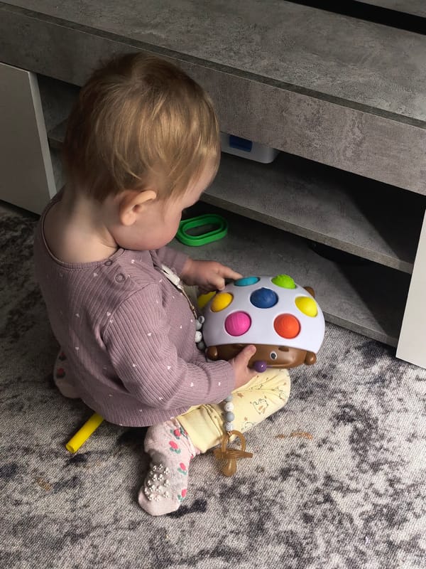 Toddler plays on foam mats in Sterlitamak home