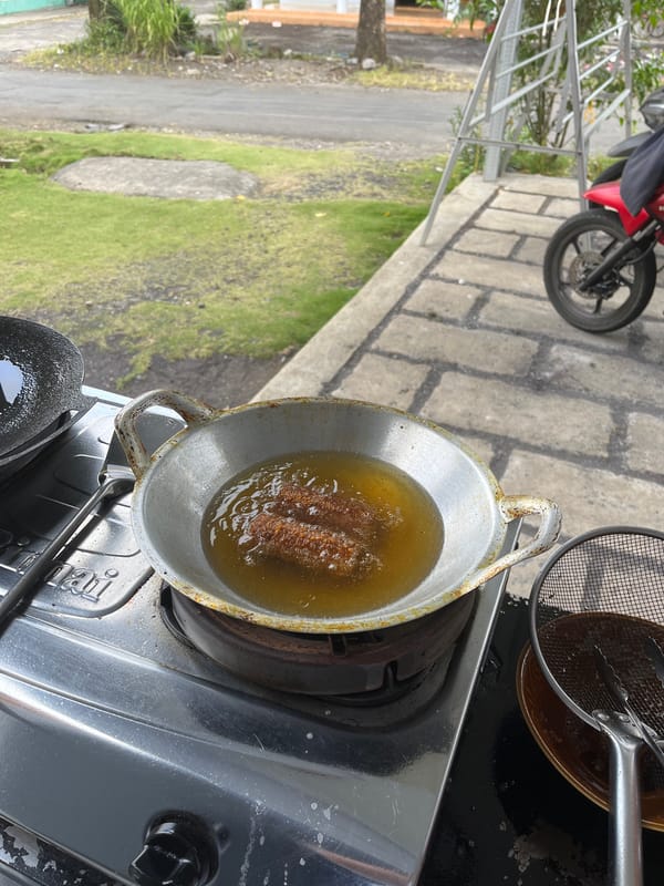 Street-side frying and parked bikes in Jambearum, Indonesia