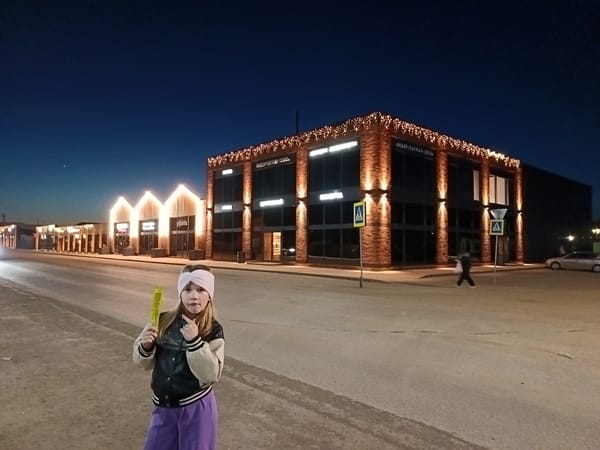 Girl with glowing stick observed on empty street in Osa