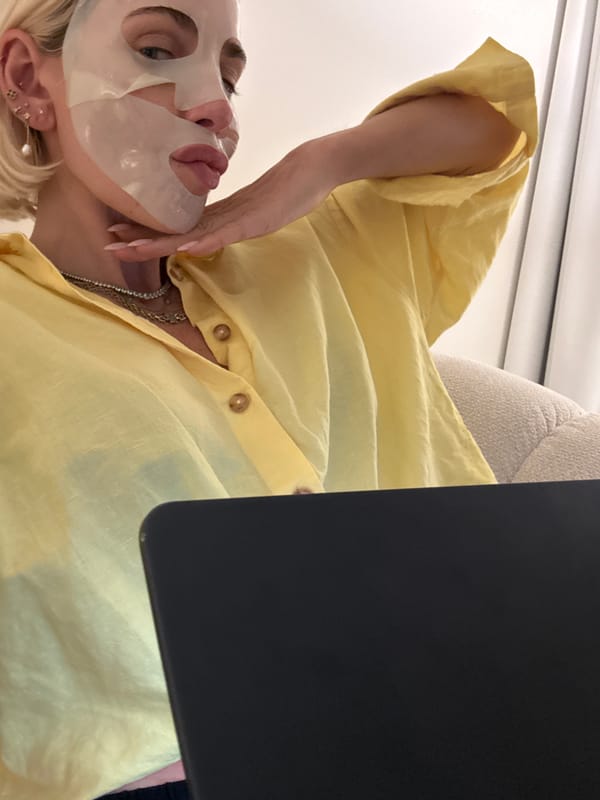Masked woman in yellow photographed in Dubai workspace