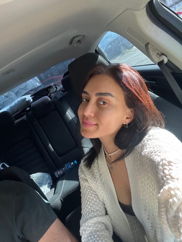 Car selfie session in Tbilisi, white cardigan and pearls