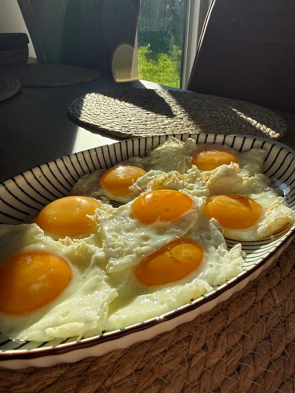 Seven fried eggs arranged on white platter in Izhevsk