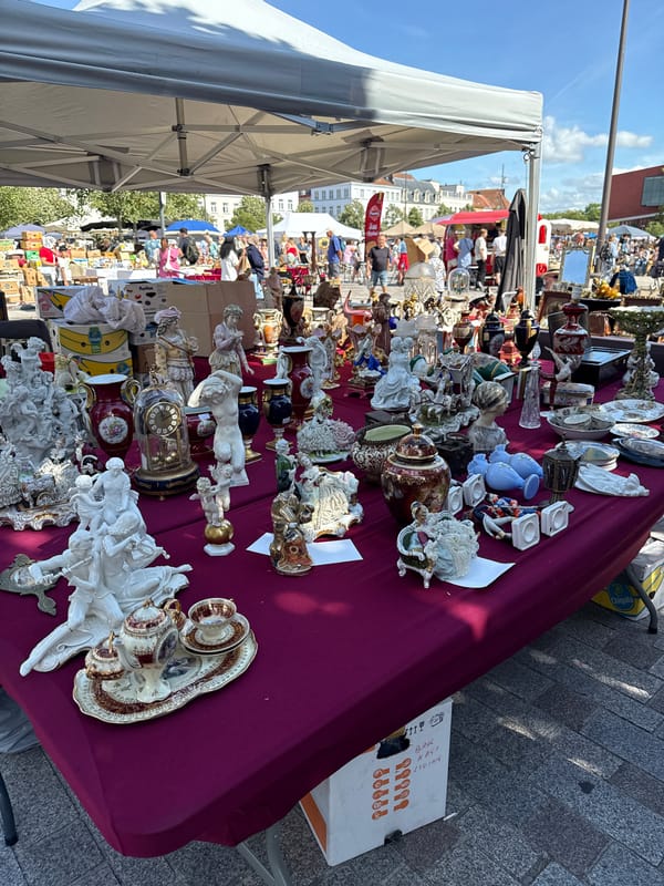 Antique flea market browsing on Bruges cobblestones