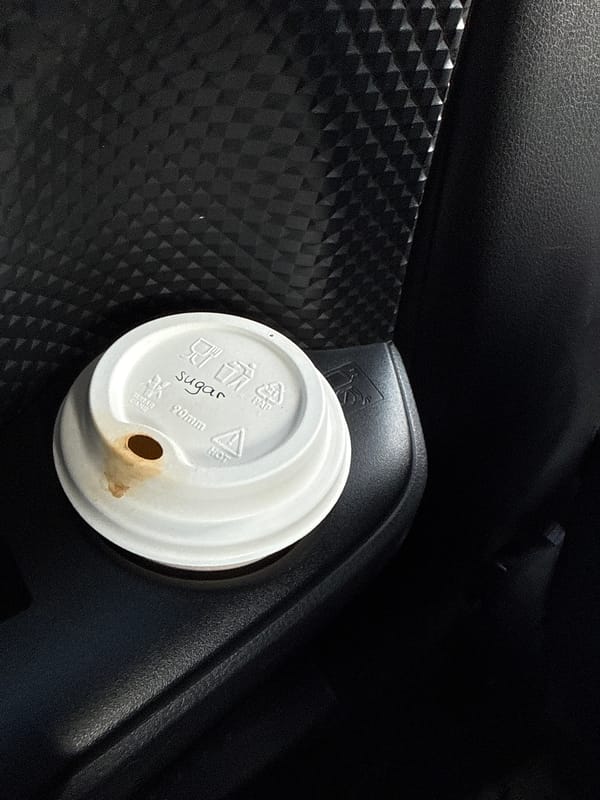 Used coffee cup lid spotted in vehicle, Serbia