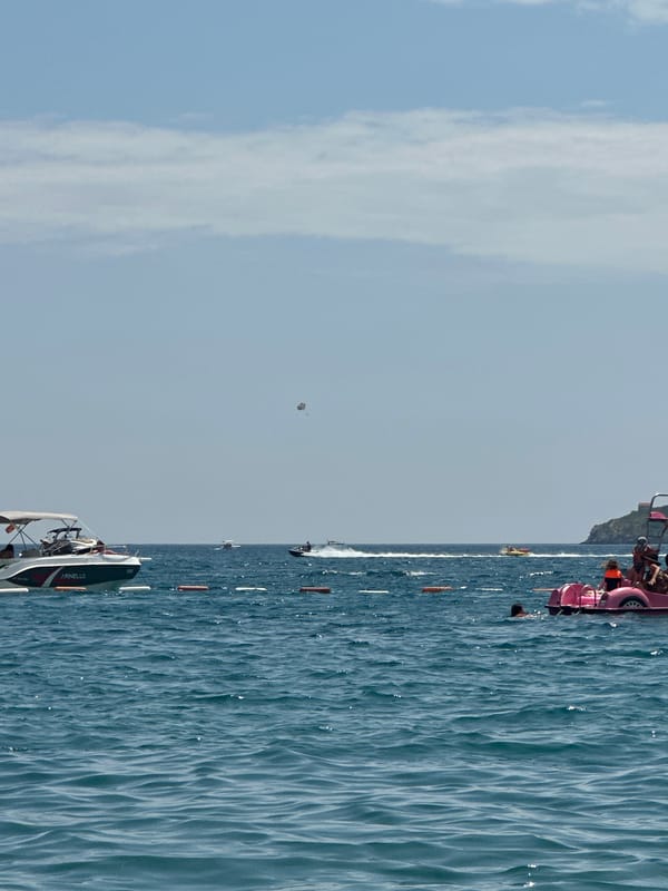 Boats and summer crowds on the water near Boreti, Montenegro