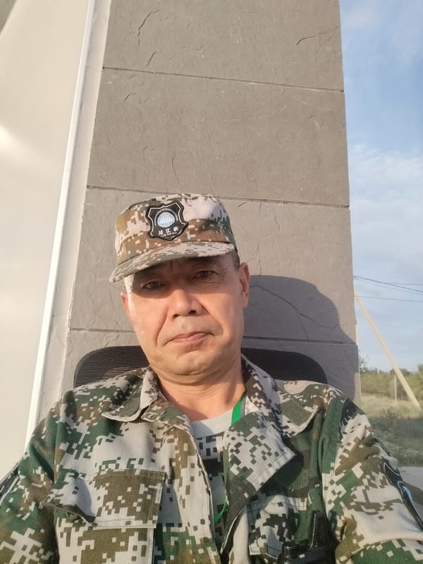 Camouflage uniform and a quiet roadside stretch, Northern Kyrgyzstan