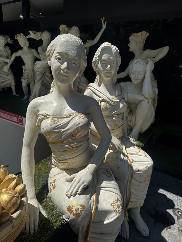 Traditional white and gold statues observed at Kuta hotel
