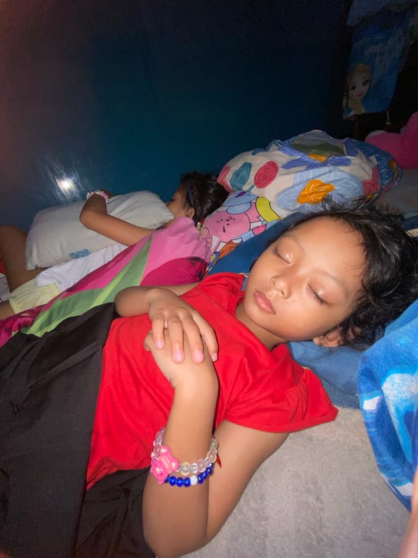 Two children sleep peacefully in Gelam, Indonesia room