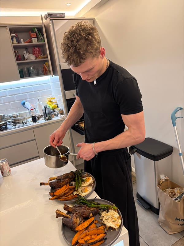 Young man plates lamb dinner in London kitchen