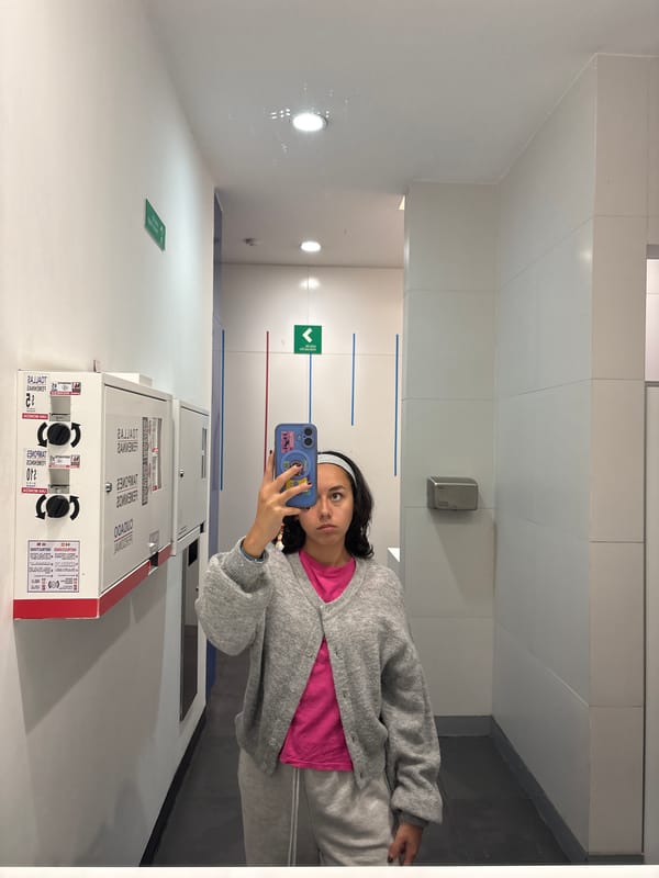 Young woman takes mirror selfies in Mexico City public facility