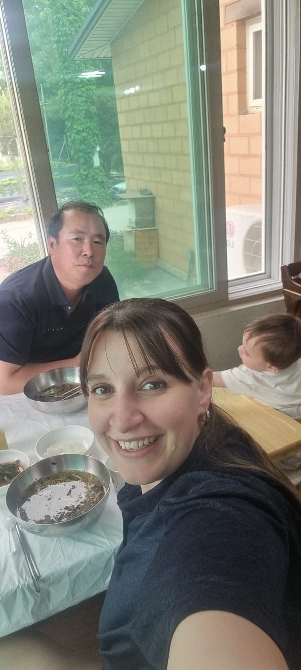 Family shares morning meal at mountain restaurant in rural Korea
