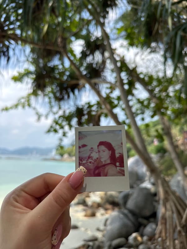 Person holds instant photo in Patong, Thailand morning