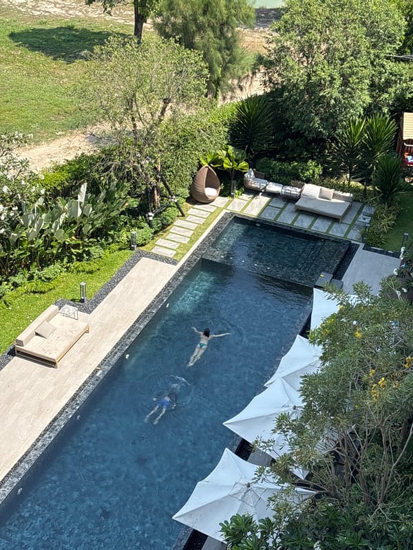 Two swimmers enjoy morning pool time in Choeng Thale