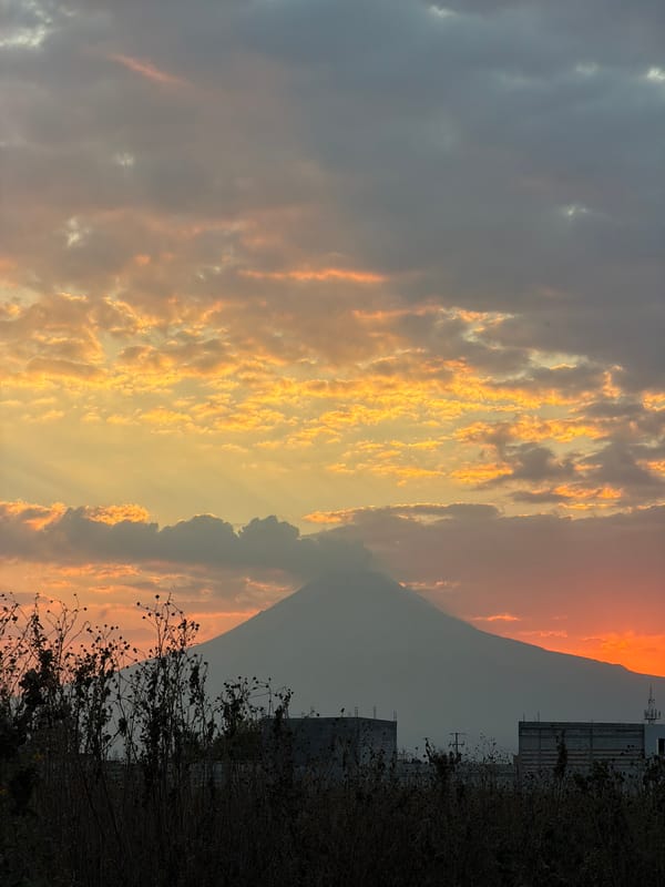 Sunrise/sunset scenes with volcano silhouette captured in San Andrés Cholula