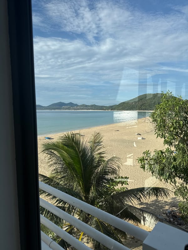 Lazy beach day views from a shaded balcony overlooking calm water