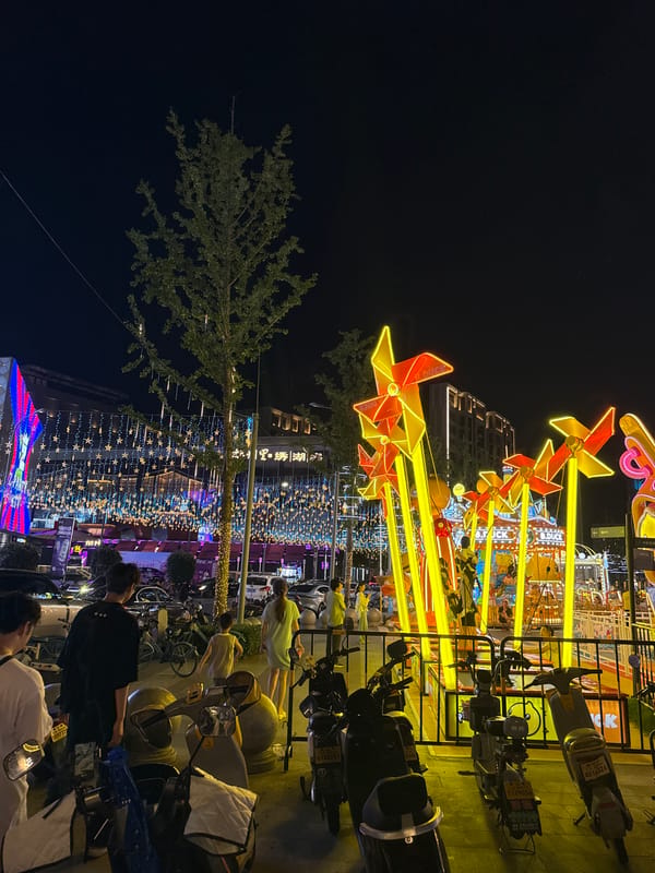 Neon-lit carnival rides and street fun in Yiwu at night