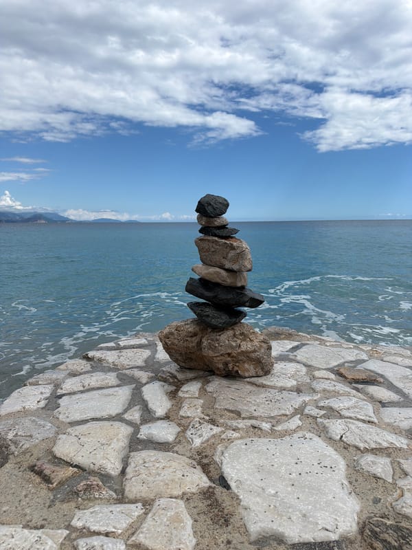 Rock cairn spotted on Montenegro coast under sunny skies