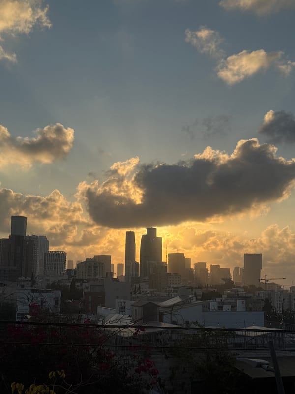Golden-hour sunset views across Ramat Gan, with an outdoor event setting up