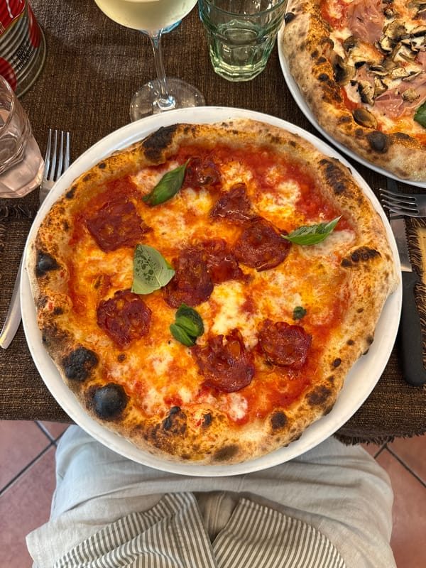 Artisan pizzas on a Milan restaurant table, top-down view